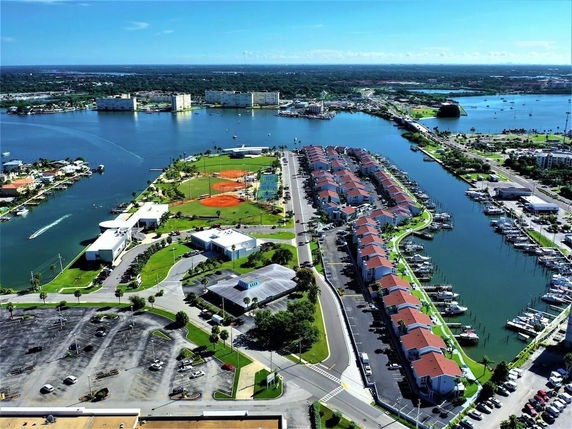 Aerial view of a waterfront residential area with boats and canals.