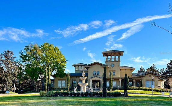 Front view of a multi-story building with architectural detailing and a central tower.