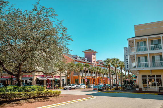 Front view of commercial buildings with balconies and storefronts.