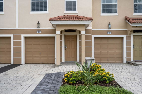 Front view of a multi-story house with two garages.