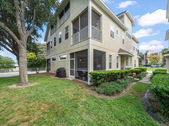 Front view of a two-story house with a screened porch and multiple windows.