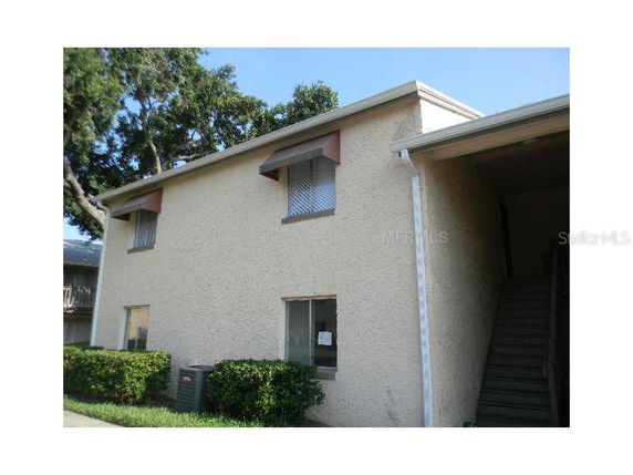 Front view of a two-story residential building with stairs.