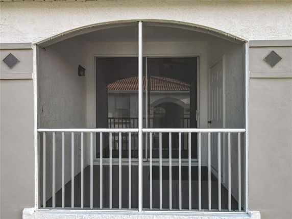 Front view of a building with a screened balcony.
