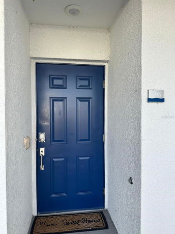 Front view of a blue door with a house number 206.