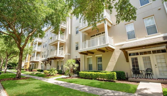 Front view of a multi-story apartment building with balconies.