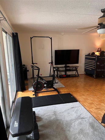Room with exercise equipment and a television.