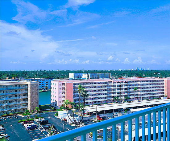 Panoramic view of multiple apartment buildings with a distant city skyline