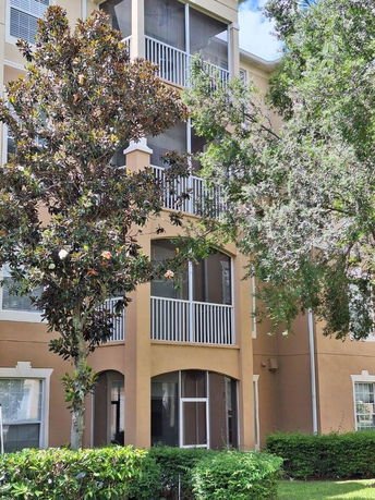Front view of a multi-story residential building with balconies.