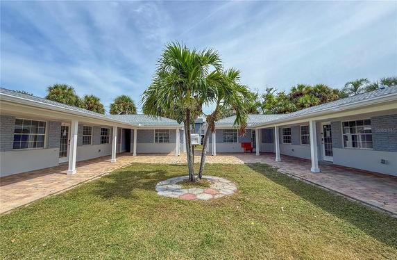 Front view of a single-story building with a covered walkway and central courtyard.