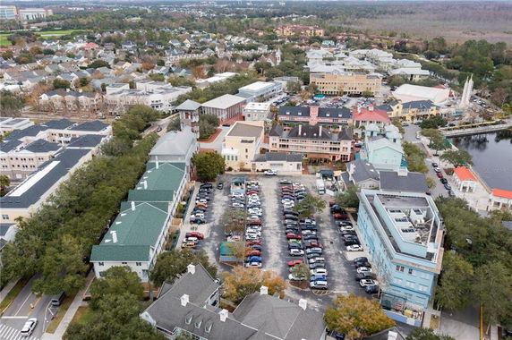 Aerial view of a town with multiple buildings and a parking area.