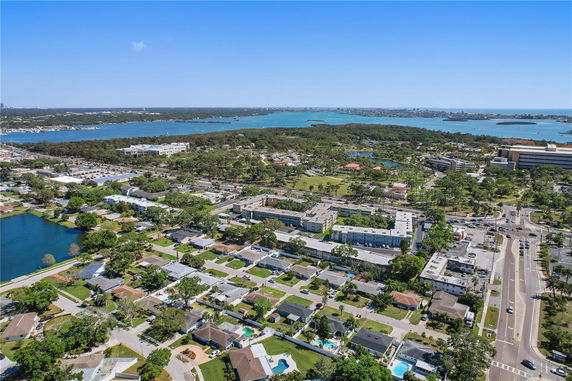 Panoramic view of a residential area with waterfront and surrounding greenery.