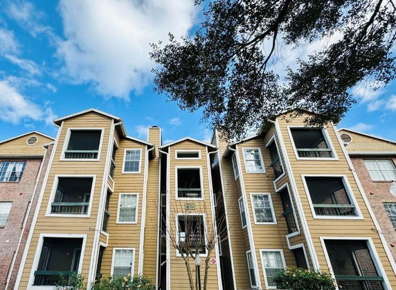 Front view of a multi-story apartment building with balconies.