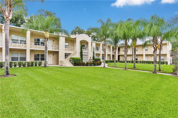 Front view of a two-story apartment building with balconies.