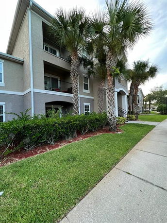 Front view of a multi-story residential building with balconies.