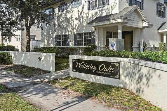 Front view of a condominium complex named Wellesley Oaks.