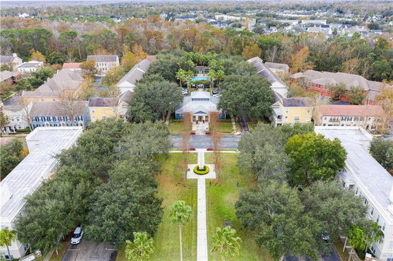 Aerial view of a community with multiple residential buildings surrounded by trees.
