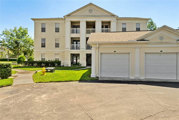 Front view of a three-story building with a double garage.
