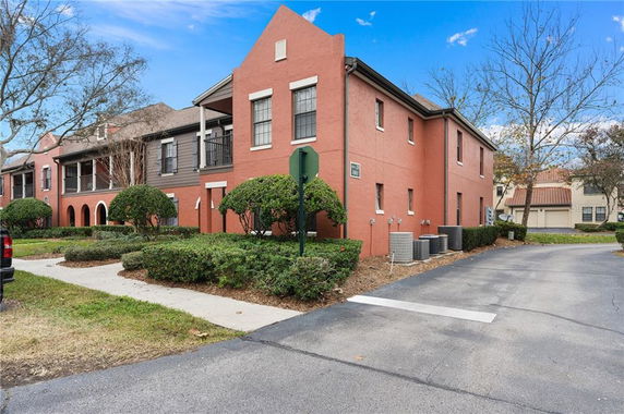 Front view of a two-story building with red exterior walls and multiple windows.