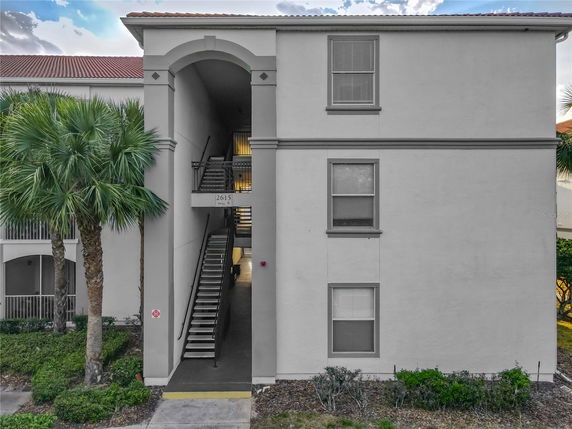 Front view of a multi-story building with an open staircase entrance.