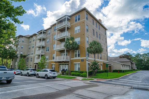 Front view of a multi-story apartment building with balconies.