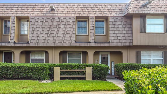 Front view of a two-story townhouse with a shingle facade.