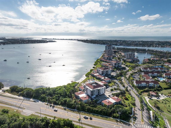 Aerial view overlooking a coastal area with buildings and a waterway.