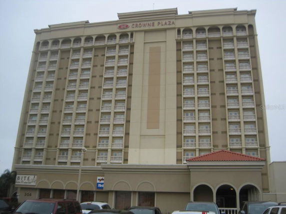 Front view of a multi-story hotel building with numerous balconies.