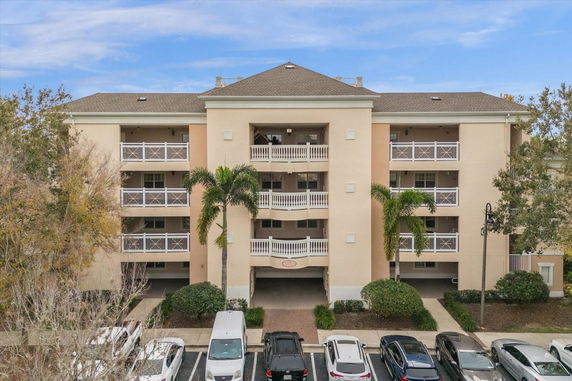 Front view of a multi-story apartment building with balconies.