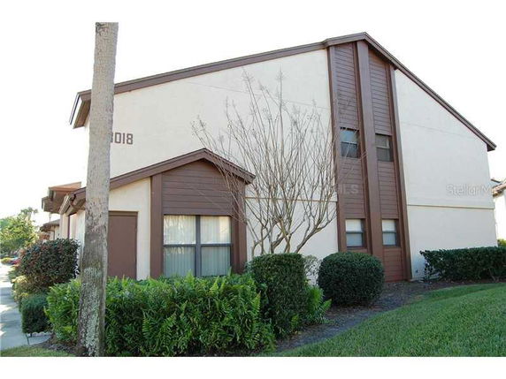 Front view of a two-story residential building with brown trim.