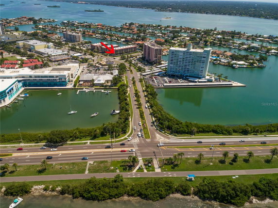 Panoramic aerial view of coastal area with roads, buildings, and water bodies.