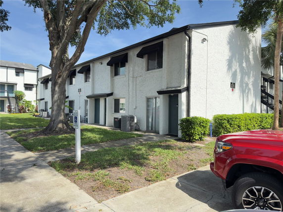 Front view of a two-story residential building with a white facade.