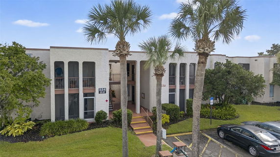 Front view of a multi-story building with balconies.