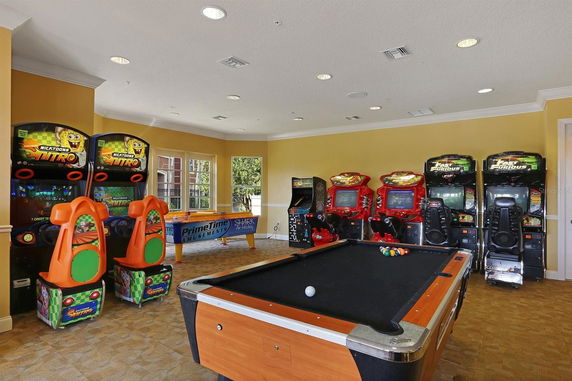 Indoor recreation area with arcade games and a pool table.