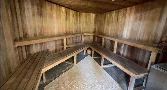 Interior view of a wooden sauna room with benches.