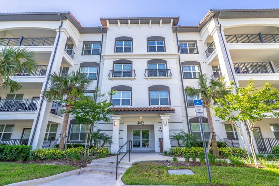 Front view of a multi-story residential building with balconies.