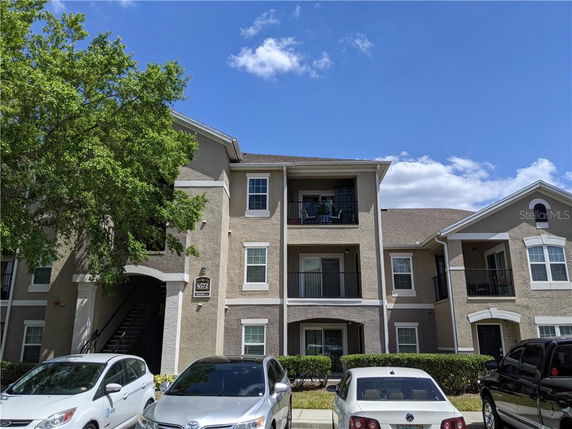 Front view of a multi-story apartment building with balconies.