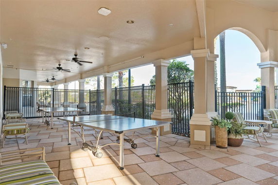 Covered recreation area with a ping pong table and seating.