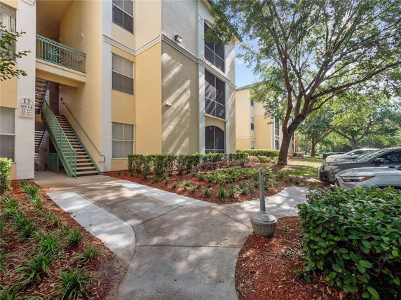 Front view of a multi-story apartment building with exterior staircases.