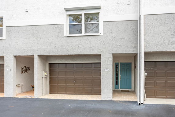 Front view of a house with a garage door and entrance.