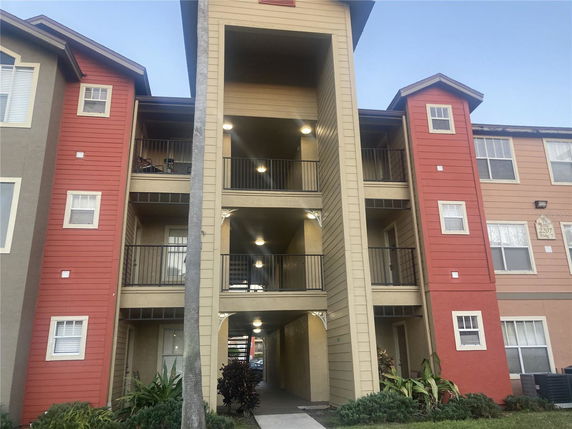 Front view of a multi-story apartment building with balconies.