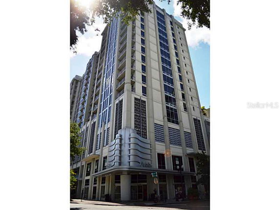 Front view of a modern multi-story building with large windows and decorative elements.