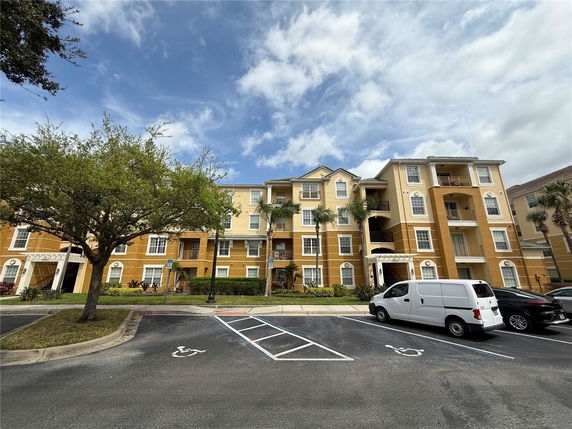 Front view of a multi-story apartment building with balconies.