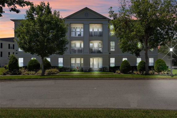 Front view of a multi-story building with symmetrical design and balconies.