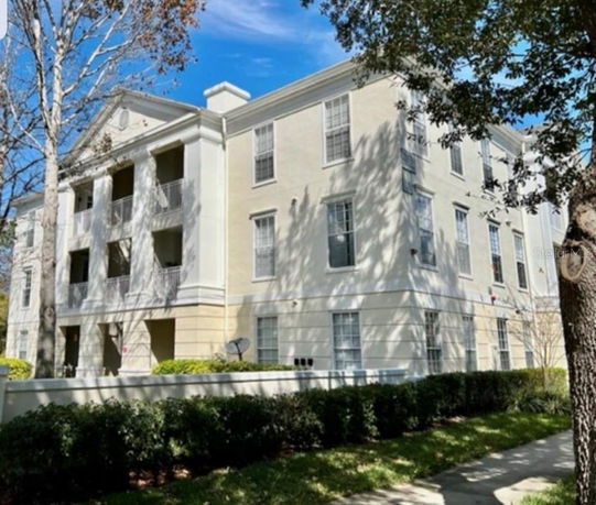 Front view of a multi-story residential building with balconies.