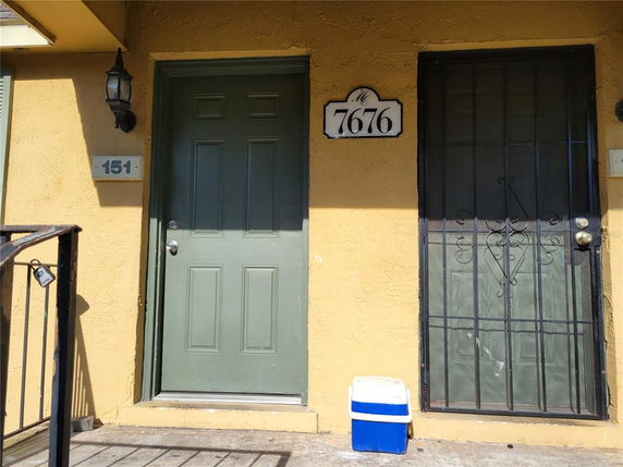 Front view of a door and gated entrance on a residential building.