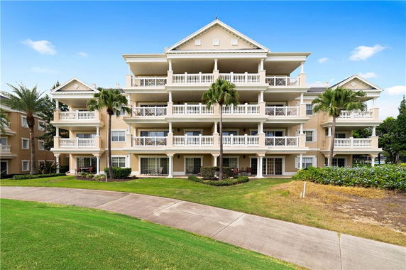 Front view of a multi-story apartment building with balconies.