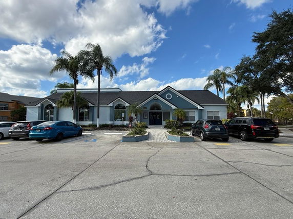 Front view of a single-story building with a gable roof and large windows.