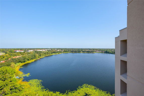 Panoramic view of a lake and surrounding landscape from a high-rise building.