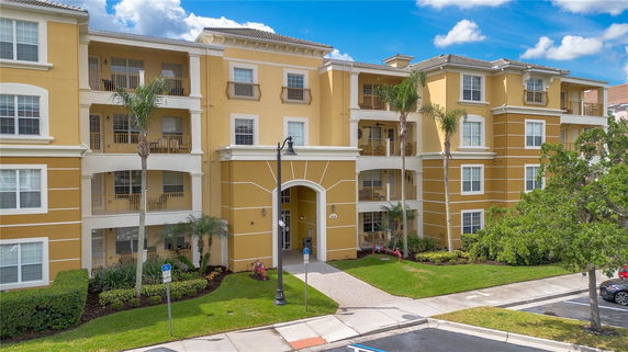 Front view of a multi-story apartment building with balconies.