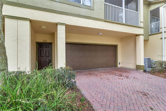 Front view of a house with a double garage and entry door.